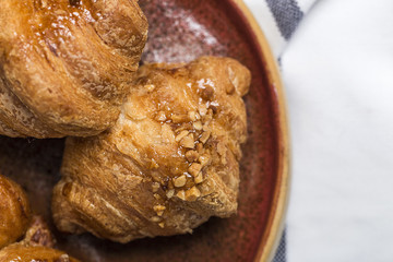 freshly baked buns with almonds. Croissants