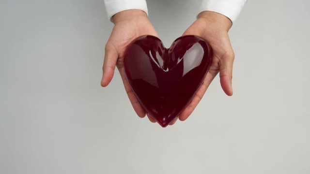 jelly-like heart in man's hand closeup. Relationship and a health concept