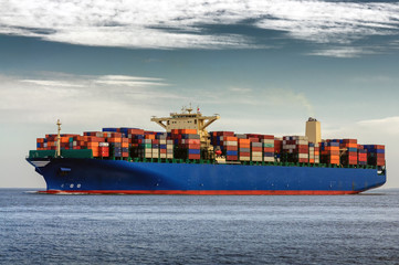 A large container ship heading out to sea
