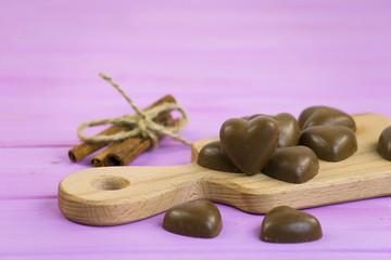 chocolate heart in a bucket on a pink wooden board