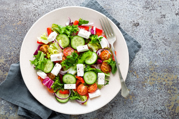 Fresh vegetable salad with feta cheese, fresh lettuce, cherry tomatoes, red onion and pepper