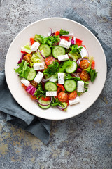 Fresh vegetable salad with feta cheese, fresh lettuce, cherry tomatoes, red onion and pepper