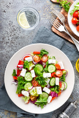Fresh vegetable salad with feta cheese, fresh lettuce, cherry tomatoes, red onion and pepper