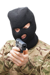 Crazy man in black mask and camouflage uniform holding gun with two hands