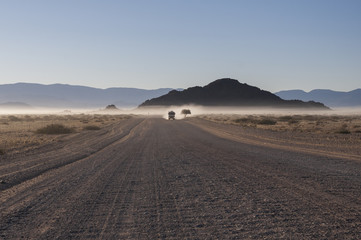 White truck on a road in the Namib desert / White truck on a road in the Namib desert in the...