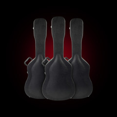 Musical instrument - Three black acoustic guitar hard case black background