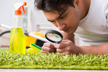 Young husband man cleaning floor at home