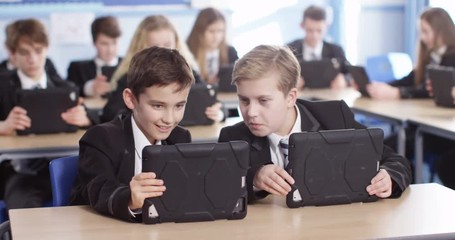 4k, High school children using digital tablets while sitting in class. - Powered by Adobe