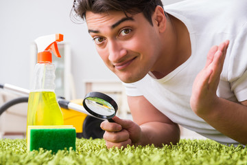 Young husband man cleaning floor at home