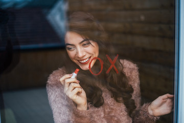 Girl drawing with red lipstick