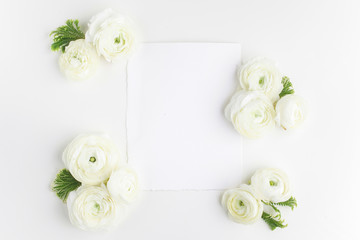 Fototapeta na wymiar Floral frame made of white flowers and leaves on white background. Floral background. Flat lay, top view.