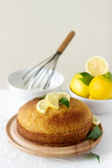 Lemon cake with whipped cream on a light background.