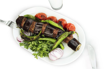 Eggplant kebab on a white background.
