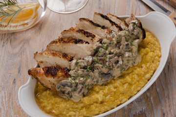 rice paella with curry fried chicken breast and mushrooms in creamy sauce