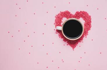 Cup of black coffee and pink hearts on pink background. St valentine's day concept, woman's day. top view, flat lay