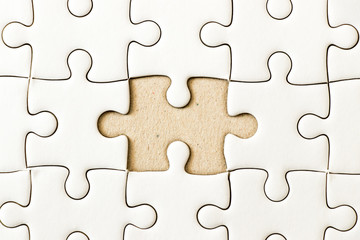 Fototapeta premium Closed up background of white plain jigsaw wait missing piece to match or fulfill