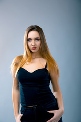 Beautiful caucasian woman dressed in black dress posing at studio.