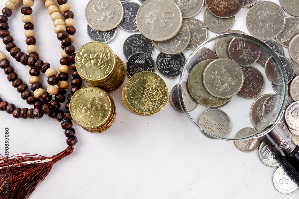 Wall mural Rosary and coins. Islamic Banking/Finance concept.