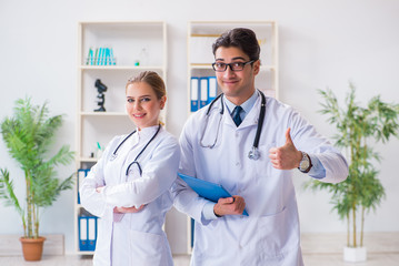 Male and female doctor having discussion in hospital