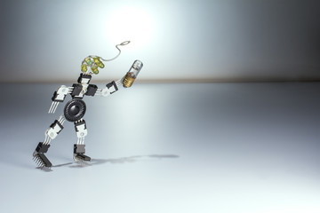 A robot with a light bulb goes and looks for something. The symbol of the idea, the search for a new, invention and innovation.