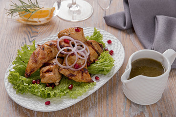 pieces of chicken fillet grilled with sauce on a plate