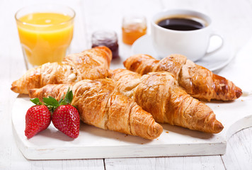 breakfast with croissants, coffee, juice and fresh fruits