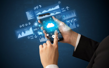 Hand using phone with financial tracking concept