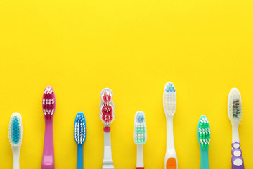 Toothbrushes on yellow background
