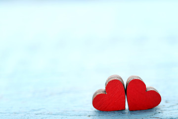 Fototapeta premium Red wooden hearts on blue table