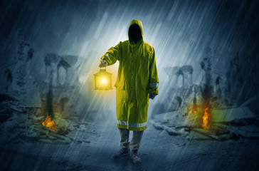 Man with a glowing lantern at a catastrophe scene