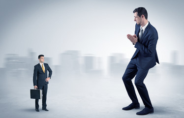 Fototapeta premium Giant businessman is afraid of small executor