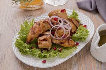 pieces of chicken fillet grilled with sauce on a plate