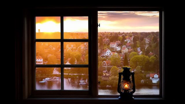 Time lapse of residential villas in Stockholm, Sweden seen through a window on a summer evening.