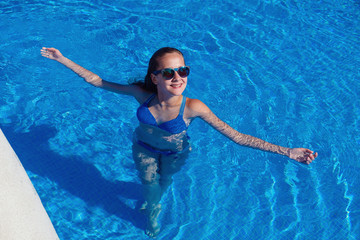 teen girl relaxing near swimming pool