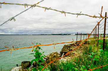 View on Fence of Barb wire protect coastline of sea