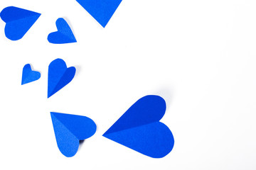 Origami paper heart blue color on white background.