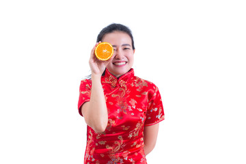 Portrait of Beautiful Young asian woman wear chinese dress traditional cheongsam or qipao. holding orange slices in front of her eyes and smile. healthy eating diet concepts. healthy food concept.