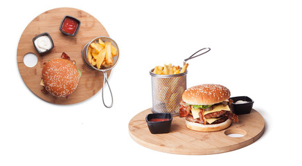 Hamburger with cheese and fries on white background seen from above, hamburger on wooden plate on white background. Fresh sandwich with beef, lettuce, tomato, bun and cheese. American fast food