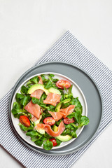 Fresh salad made of salmon, tomatoes and avocado