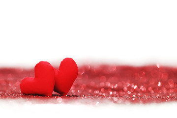 Red textile hearts on glitters