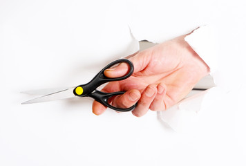 Fingers cut with scissors through a hole on a white background. Concept of a man's hand with a cutting tool isolated. Horizontal image.