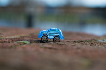 Fototapeta na wymiar blue car on brick wall