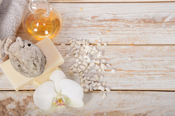 gray natural soap with honey and body oil and a cosmetic face mask with place for tekst