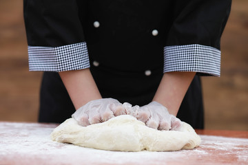 the cook makes flour for baking on the table