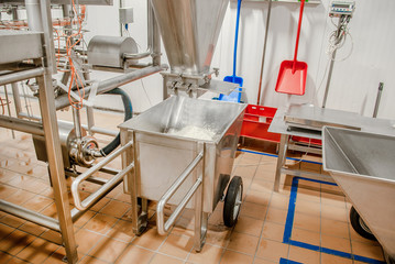 Manual wheelbarrow to collect cheese from the cheese machine at the dairy plant