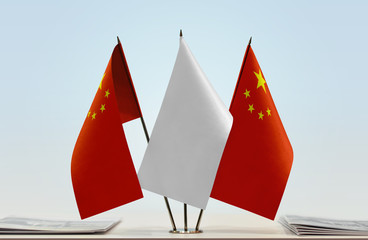 Two flags of China with a white flag in the middle