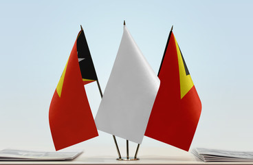 Two flags of East Timor with a white flag in the middle