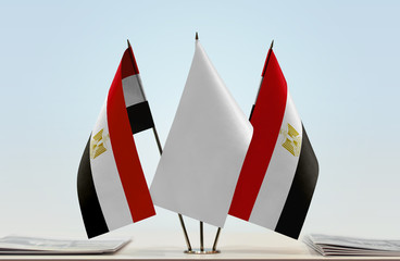 Two flags of Egypt with a white flag in the middle