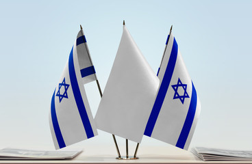 Two flags of Israel with a white flag in the middle