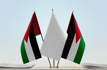 Two flags of Jordan with a white flag in the middle